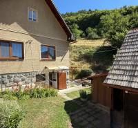 A family house in Horné Hámre, showing a grassy yard and the surrounding nature.