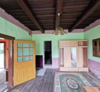 Wooden ceiling, open door, and wardrobe in a family house.