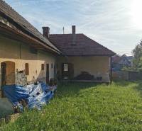 An older family house in Nitrianske Sučany on Nitrianske Sučany Street with a grassy plot.