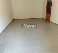 Empty room with a floor and light walls in a studio apartment.