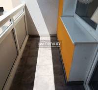 A balcony with tiles and railing in a 1-room apartment, suitable for relaxation and leisure.