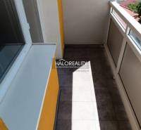 A balcony of a one-room apartment with glazing and a view of the surroundings of Krompachy.