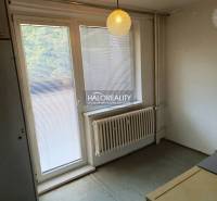Interior of a 1-room apartment with blinds on the window and pendant lighting.