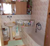 Bathroom in a family house with a bathtub, sink, and mirror.