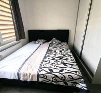 Bedroom in a 3-room apartment with a double bed and a wardrobe.