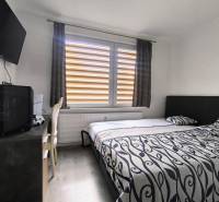 Bedroom with a bed, television, and a desk in a 3-room apartment.
