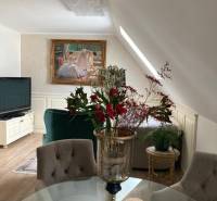 In the interior of a 2-room apartment, there is a dining table and a floral arrangement.