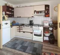 A kitchen in a family house with a countertop, stove, and refrigerator, without people present.