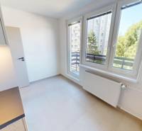 Kitchen in a 2-room apartment with large windows and a radiator.