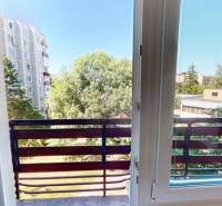 View from a 2-room apartment on Centrum I Street in Dubnica nad Váhom, with a balcony and greenery.