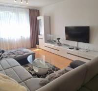 Living room in a 3-room apartment with a sofa, TV, and coffee table.