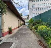 Exterior of a family house in Ilava with an alley and a view of a taller building.