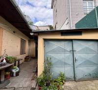A yard in Ilava with a garage and outdoor seating at a family house.