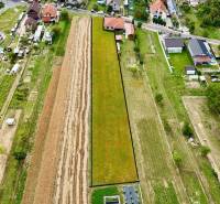 An aerial view shows residential plots in Trenčianske Jastrabie surrounded by houses and gardens.