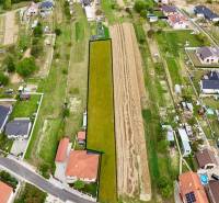 Aerial view of properties in Trenčianske Jastrabie with family houses and road infrastructure.