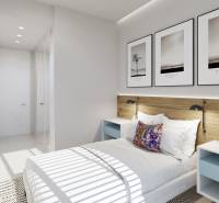 A bright bedroom in a three-room apartment with white furniture and decorative pictures on the wall.