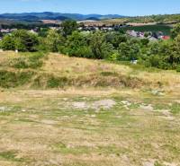 Development plots in Záhradné with views of the countryside and nearby buildings.
