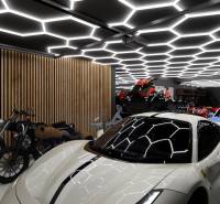 Showrooms with cars, motorcycles, and unique ceiling lighting in the garage.