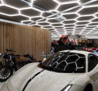 Motorcycles and sports vehicles in commercial spaces with modern lighting.