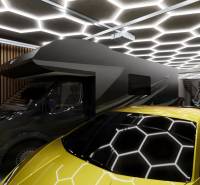 Curtain rods in a commercial space with a light ceiling, a caravan, and a yellow sports car.