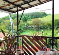 The terrace of a family house in Český Brezov with a view of green hills and gardens.