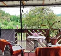 The balcony of a family house in České Brezové, seating and a view of greenery.