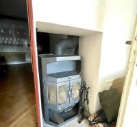 The interior of a family house with a fireplace and heating accessories.