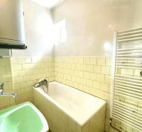 Bathroom in a family house with a bathtub and a sink in a family house.