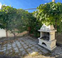A garden at a family house in Veľké Blahovo with a vineyard and an outdoor fireplace.