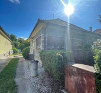 A family house in Veľké Blahovo with an access road and a garden under the clear sun.