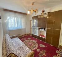 Living room in a family house with carpets and a sofa set.