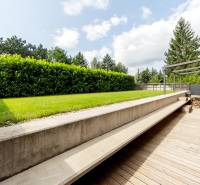 A terrace with a wooden decor and green lawn at a 3-room apartment on Devínska Road.