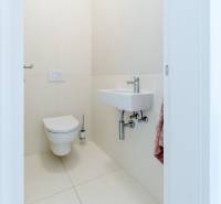 Bright toilet with a sink in a 3-room apartment, minimalist style.
