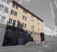 The building on Gunduličova Street in Bratislava - Old Town surrounded by cars in a row of buildings.