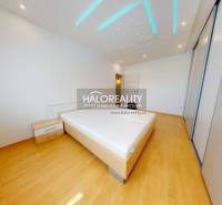 Bedroom in a 4-room apartment with wooden flooring and a bed.
