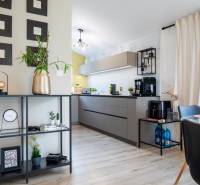 Interior of a family house with an open kitchen, modern furniture, and decorations.