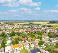 A view of family houses in Čierna Voda, surrounded by nature and road infrastructure.