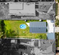 Aerial view of a family house in Čierna Voda, with a swimming pool and garden.