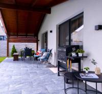 The terrace of a family house in Čierna Voda with comfortable seating and a grill.