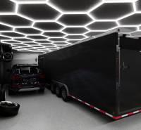 Commercial space with a car, trailer, light ceiling, and art posters on the wall.
