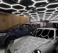Auto underlit with hexagonal ceiling lights, wooden wall, garages.