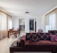 Living space with a dining table and sofa in a family house.
