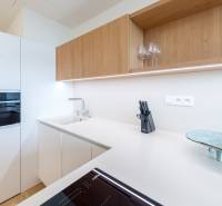 The kitchen in a 2-room apartment with white and wooden cabinets, Whirlpool appliances.