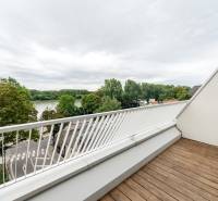 A balcony in Bratislava - Old Town on Floriánska Street with a view of greenery and the river.