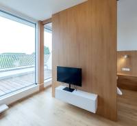 A room in a 2-room apartment with a TV, a mirrored wardrobe, and a large window to the terrace.
