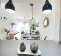 Dining area with decorations and a large window in a 3-room apartment.