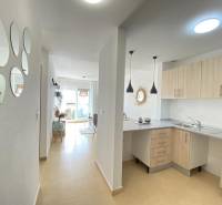 A kitchen with a dining area and mirrors in a 3-room apartment, bright and cozy atmosphere.