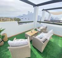 A terrace with a view in a 3-room apartment, with seating and artificial grass.