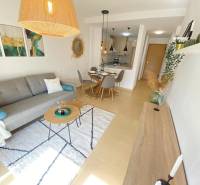 A bright living space in a 3-room apartment with a carpet and a dining area.