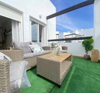 A terrace with comfortable seating and a table in a 3-room apartment.